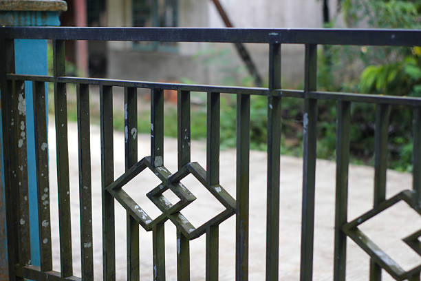 istock Black Iron Fence with Geometric Square Ornament Design 2253536443