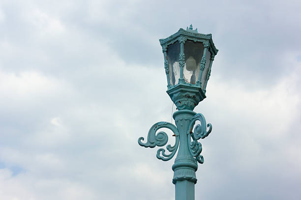 Antique blue lamp isolated on sky background, cloudy
