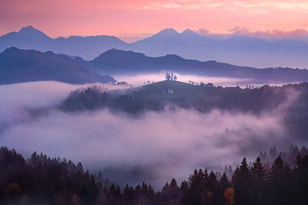 We waited for sunrise in the Dolomites, and our patience was rewarded as a beautiful morning glow slowly colored the hills and fogs before us