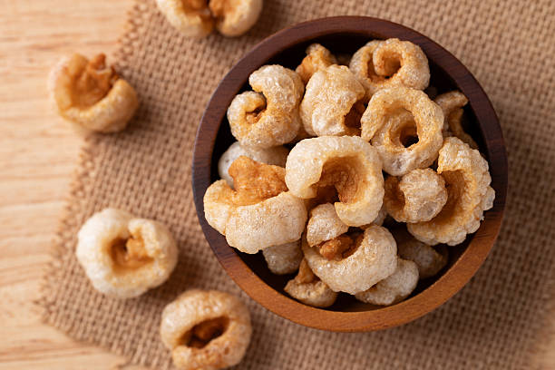 istock Pork rind in a wooden bowl, Table top view 2253539899