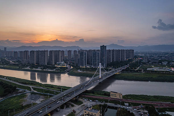 istock At dusk, a bridge spanning the river and city skyscrapers. 2253540488