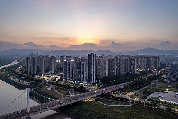 istock At dusk, a bridge spanning the river and city skyscrapers. 2253540492