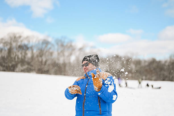 Man catching or throwing snow creating a splash of white powder