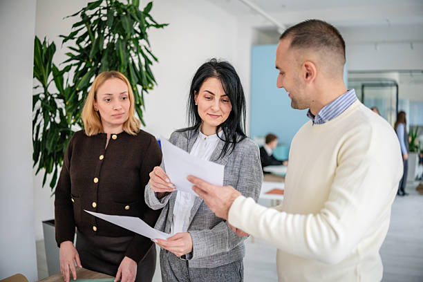 istock Business professionals engage in discussion and collaboration in modern office setting during work hours 2253541813