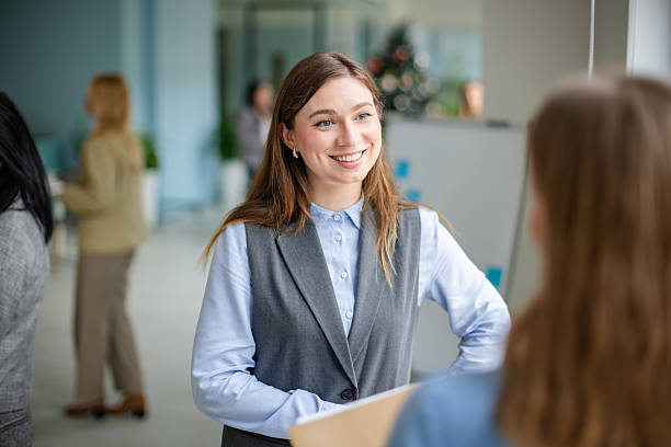 istock Conversation between coworkers in a modern office during work hours with natural light 2253542064