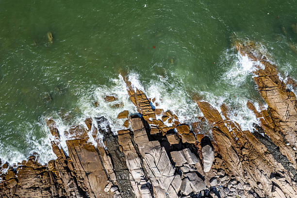 The waves crashed against the rocks, whipping up spray.
