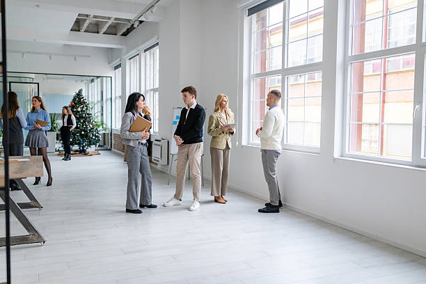 istock Group of adults engaged in conversation and collaboration in a modern office space during daytime 2253543558