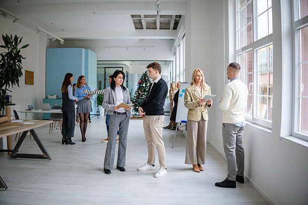 istock Group of adults working in an office setting while collaborating on a project during the day 2253543716