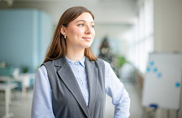 istock Young professional woman looking thoughtful while standing in an office setting during working hours 2253547454