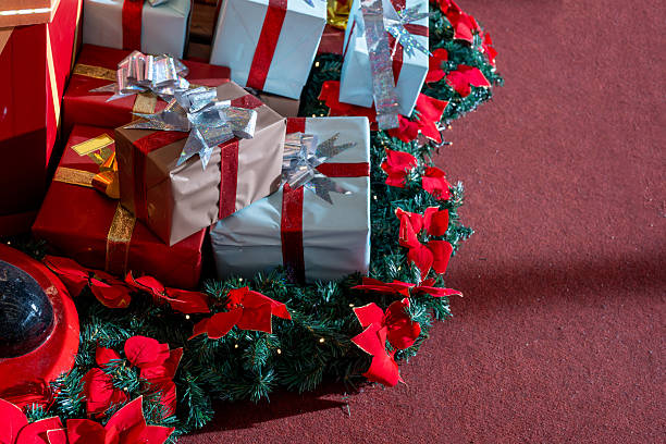 Photo of Christmas presents and gift boxes with bow and ribbon in Christmas decorated background
