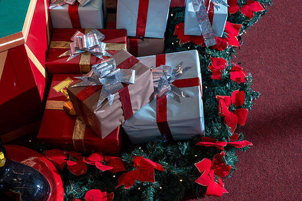 Photo of Christmas presents and gift boxes with bow and ribbon in Christmas decorated background