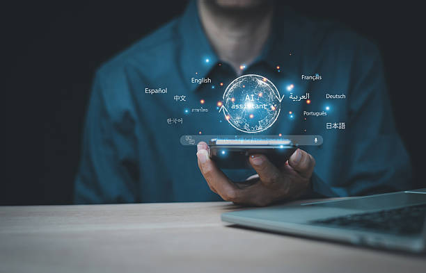 istock User use an AI assistant on a smartphone for language translation. A futuristic globe hologram shows multilingual text. Concept of global business communication, machine learning, and NLP technology. 2253547954