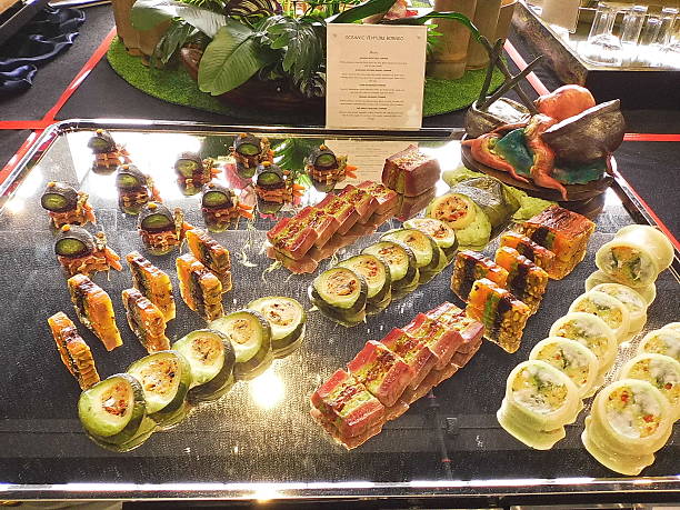 Sabah Hospitals Fiesta, 21–23 November 2025, SICC, Kota Kinabalu, Sabah.  A sleek black surface featuring neatly aligned rolls and skewers, accented with greenery and signage. The minimalist layout highlights precision and contrast in gourmet buffet styling.