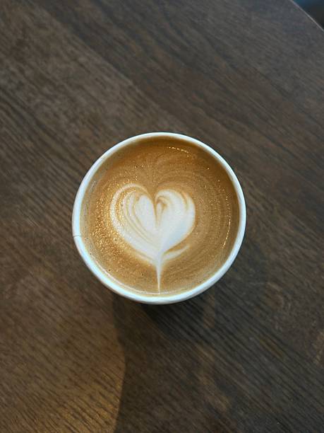 A beautifully crafted latte, featuring creamy foam art on top of rich espresso. Perfect for coffee-related projects, this image captures the warmth and inviting nature of a classic cafe experience.