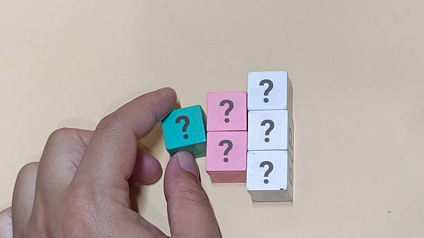 istock Hand holding question mark block near colorful blocks with query signs 2253552632