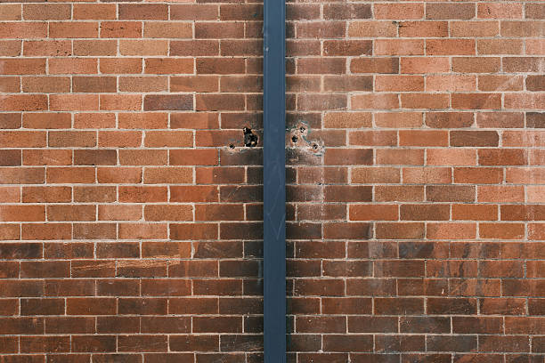 Old blue metal pipe on a brown brick wall