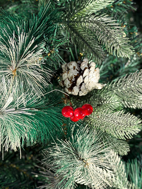 istock Image of realistic artificial christmas tree with pine and spruce needles, featuring decorative berries and pine cones 2253555121