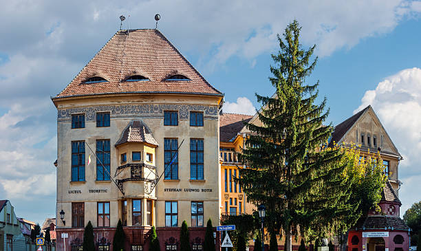 Medias, Romania - octoder 20.2025. The historic facade of the Stephan Ludwig Roth Theoretical High School, featuring traditional Saxon architecture and eye-shaped dormer windows in Medias