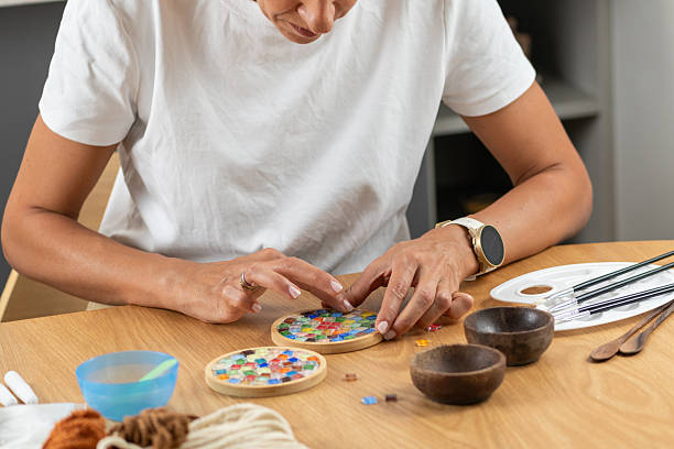 istock Woman creating decorative coasters in a relaxed home craft setup. Emphasizes precision, material control, and thoughtful artistic routine. 2253558455