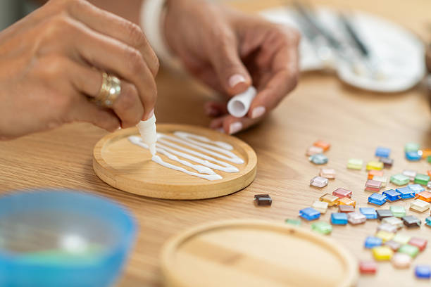 istock Woman using glue to assemble coaster components at home. Shows controlled placement, material awareness, and patient creative work. 2253558644