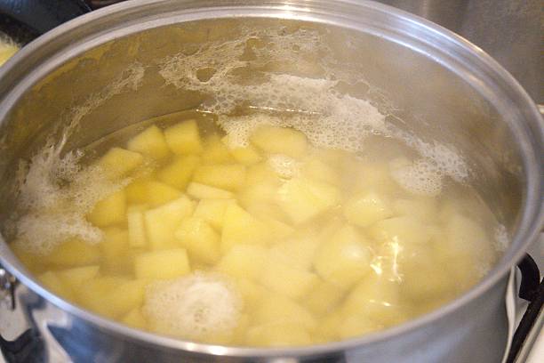 istock Cooked Diced Potato in Water in Cooking Pan Close-Up 2253559155