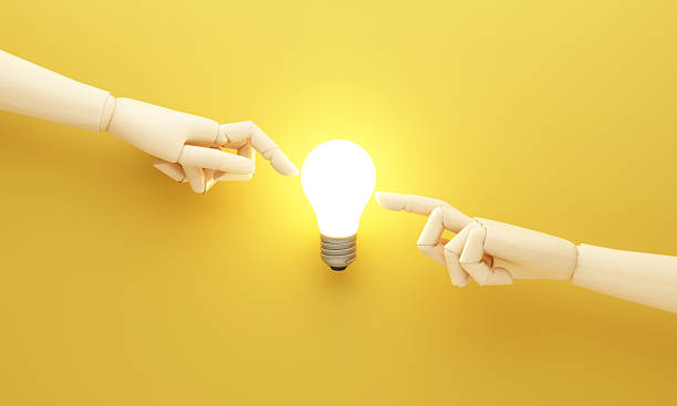 istock Creative idea concept with two wooden mannequin hands reaching toward a glowing light bulb on yellow background symbolizing inspiration innovation and connection 3d rendering 2253559275