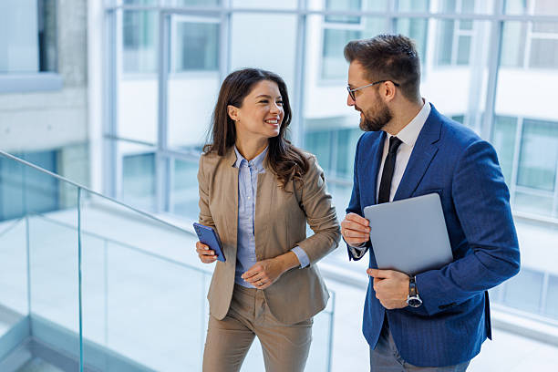 istock Business colleagues collaborating and discussing in modern office building 2253559367