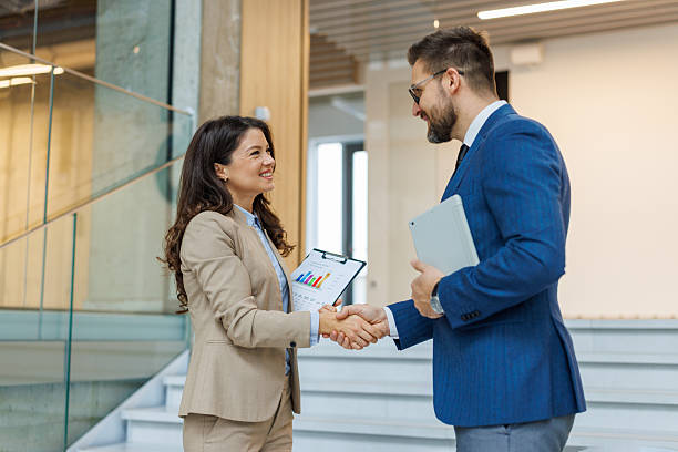 istock Business people shaking hands confirming partnership deal 2253559385