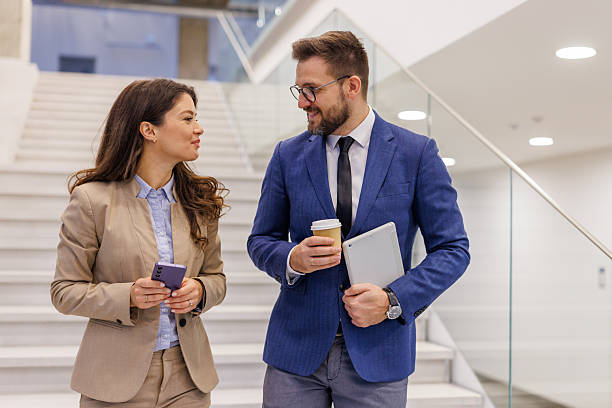 istock Business colleagues collaborating while walking up office stairs 2253559416