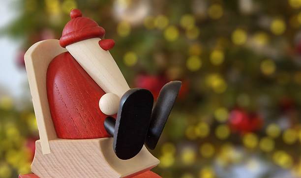 Wooden Santa with Christmas tree in background