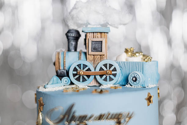 A truly delightful blue birthday cake adorned with a charming train design and light, fluffy clouds, making it the perfect treat for a childs special occasion or themed party