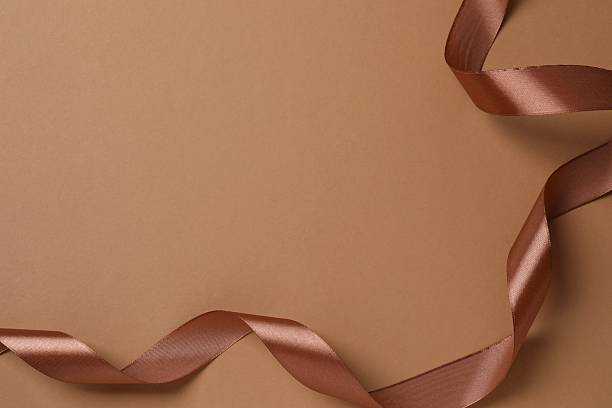 Red Ribbon on golded paper background.