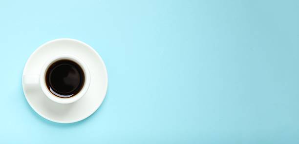 istock Cup of coffee on blue background 2253561766