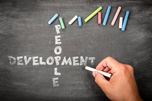 istock People and Development Concept Written with Chalk on Blackboard by Hand 2253562382