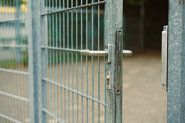 istock This is a closeup view of a robust metallic gate featuring a secure lock, which is presently in an open position, thereby facilitating easy passage and significantly improved access 2253562573