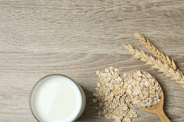 istock Composition with oatmeal flakes on gray background. Cooking breakfast 2253562593