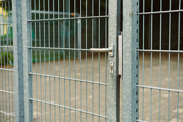 istock This highquality metal fence gate features a reliable lock mechanism, ensuring secure enclosures that are perfect for urban areas where safety and security are essential for properties and gardens 2253562709