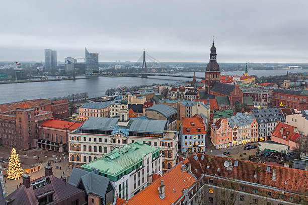 Heritage rooftops and contemporary towers align along the river, presenting Riga as a composed, forward-looking European capital.