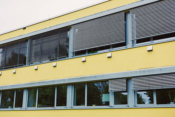 istock This modern building features a bold yellow facade with stylish window blinds, exemplifying contemporary design and capturing the essence of modernism in architecture and aesthetics 2253563809