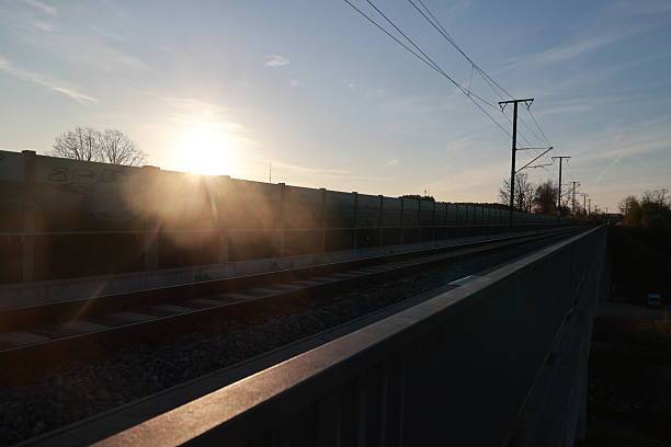 istock The sun is setting behind a fence and the sky is blue 2253563890