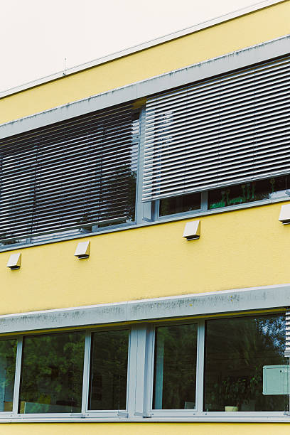 istock This modern design features a striking yellow exterior and stylish window shading, enhancing its aesthetic and making it stand out in the urban cityscape with contemporary style and elegance 2253563922