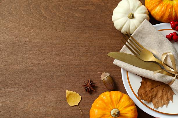 istock Rustic holiday table setup. Top view with plates, cutlery and autumn decorations. Empty space for your text 2253565627