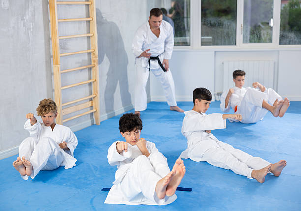 istock Preteen attendee of karate classes practicing strikes in supine position 2253566590