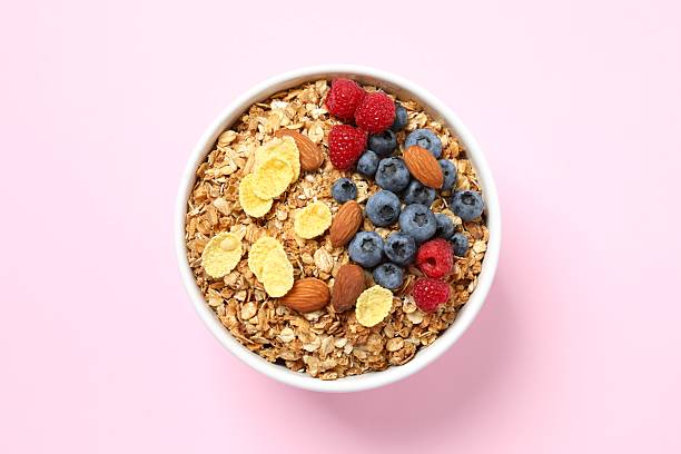 istock Delicious granola with berries on color background 2253567127