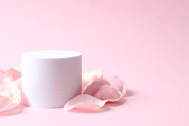 istock Pink rose petals with podium on a color background 2253567152
