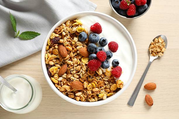 istock Delicious granola with berries and yogurt on a light background 2253567592
