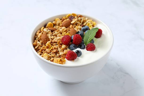 istock Delicious granola with berries and yogurt on a light background 2253567603