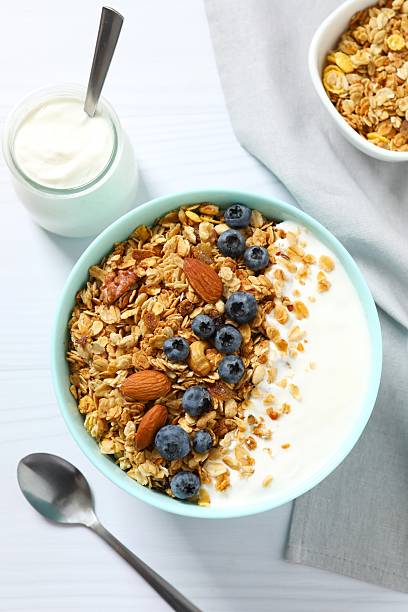 istock Delicious granola with berries and yogurt on a light background 2253569792