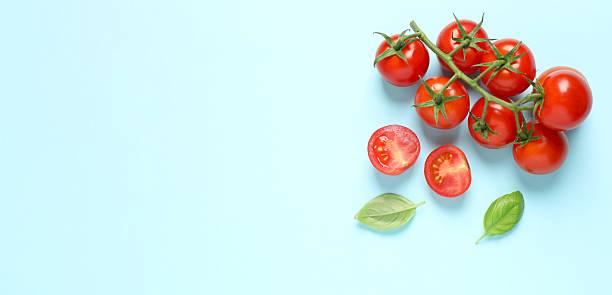 istock Bunch of fresh red tomatoes on color background, top view 2253570476