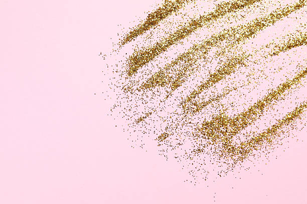 istock Beautiful shiny gold glitter on pink background, top view 2253570843